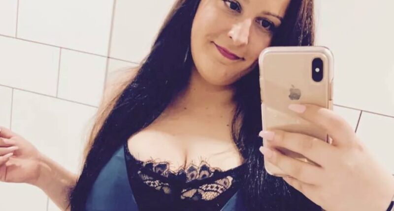 Selfie of a woman in a blue dress.