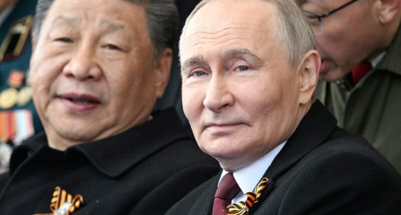 Vladimir Putin and Xi Jinping at a military parade.