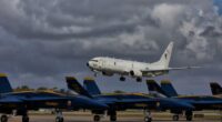 Boeing P-8 Poseidon flying over Blue Angels jets.