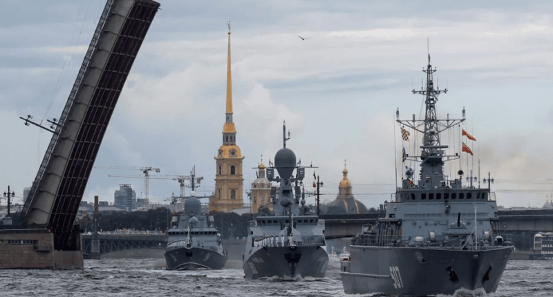 Three Russian warships sailing past a raised drawbridge in St. Petersburg.