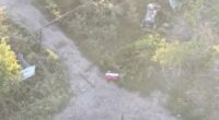 Aerial view of Russian soldiers with a flag in Yablunivka, Ukraine.