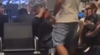 A man slapping a woman in an airport terminal.