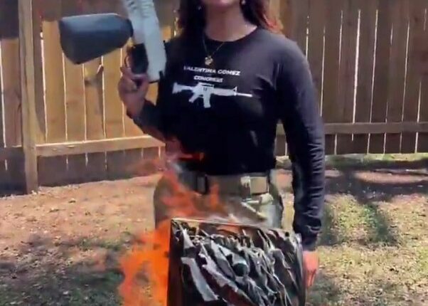 Woman burning a Quran with a flamethrower.