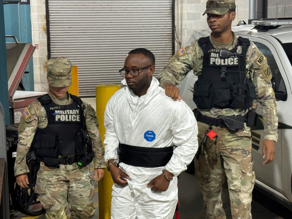 Sgt. Quornelius Radford, a shooting suspect, escorted by military police.