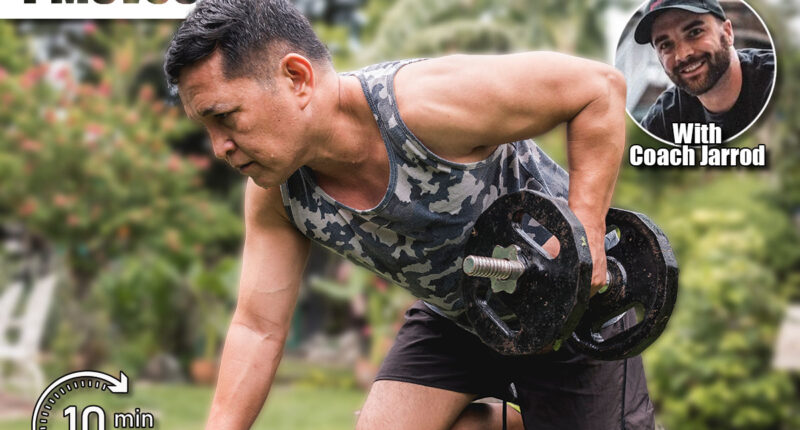 A fit and healthy asian man exercises outdoors at his home, doing one arm dumbbell rows on a bench.The 4 Strength Moves Every Man Over 50 Needs for Longevity. Cover