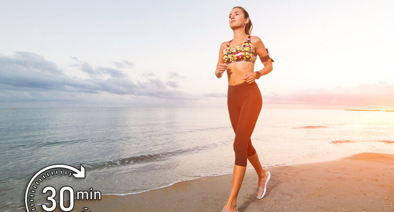 Cute fit tanned girl in sport top and leggings running on beach at sunset. Fitness, workout and healthy lifestyle concept. Blue sky in the morning with clouds. This Simple Japanese Walking Trick Could Help You Live Longer. Cover