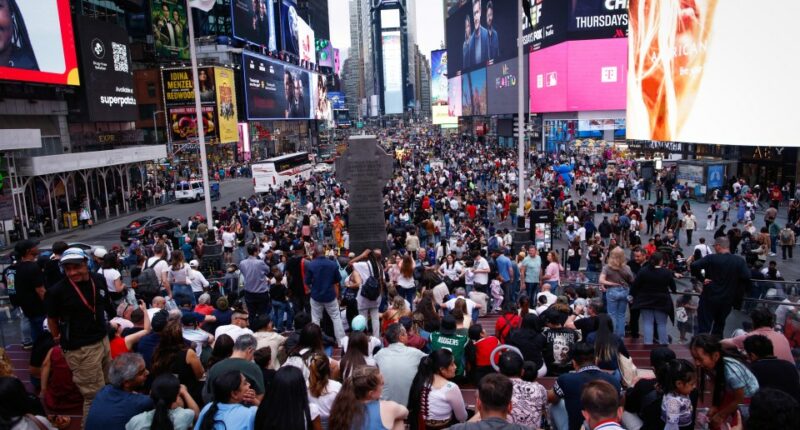 A large crowd of people in Times Square.
