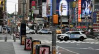 NYPD vehicles blocking a street in Times Square.
