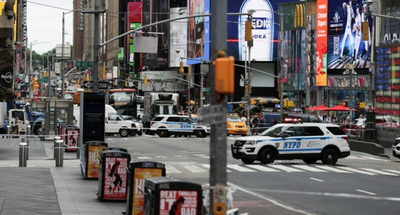 NYPD vehicles blocking a street in Times Square.