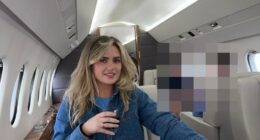 Woman sitting in a private jet, holding a drink.