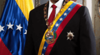 Nicolás Maduro in formal wear with Venezuelan flag.