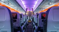 Airplane passenger cabin aisle at night.