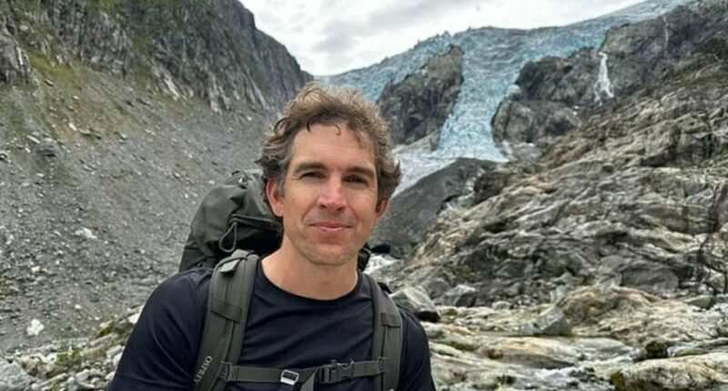 Alec Luhn, a reporter, hiking near a glacier.