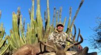 Hunter posing with a large desert mule deer.