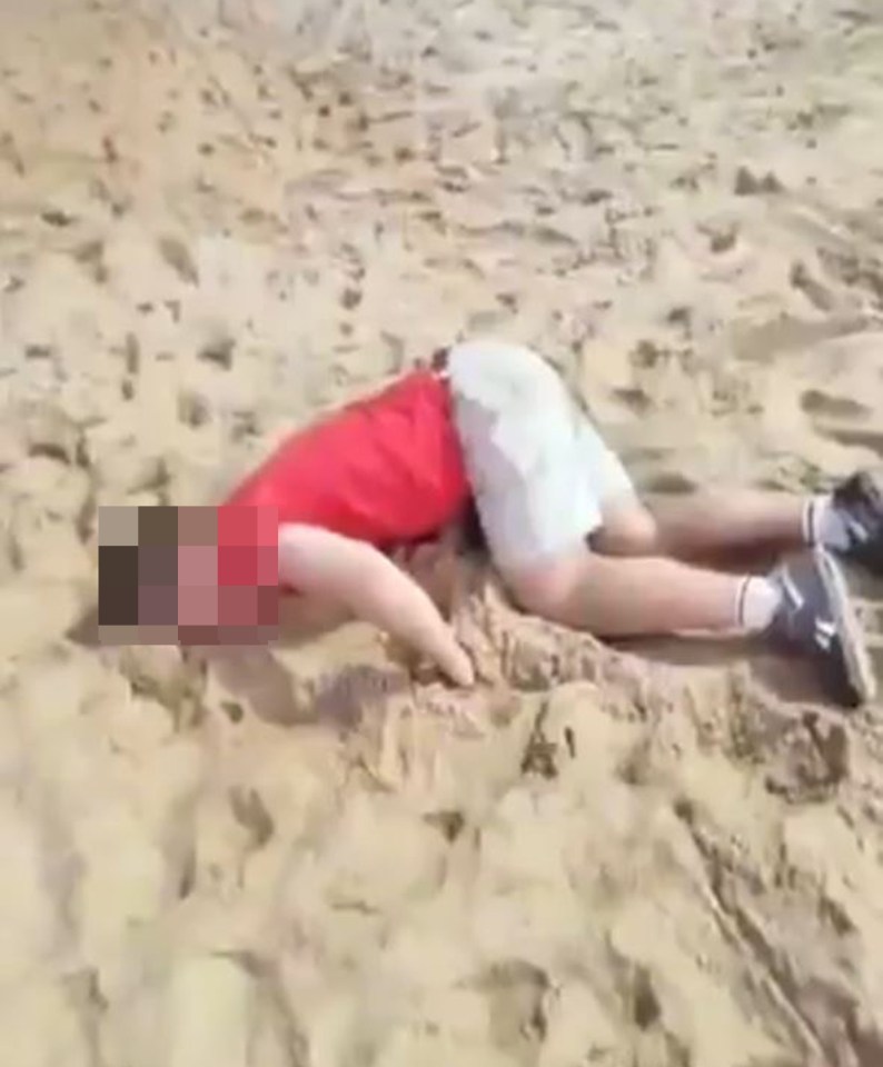 Drugged tourist lying on a beach.