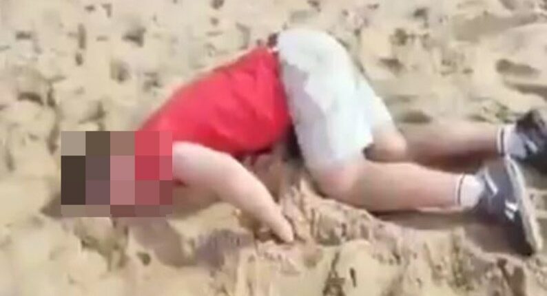 Drugged tourist lying on a beach.