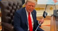 President Trump holding a golf club presented to him by President Zelensky.
