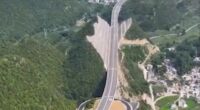 Aerial view of a highway cut through a mountain in China.