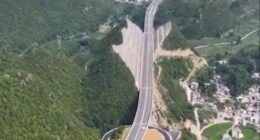 Aerial view of a highway cut through a mountain in China.