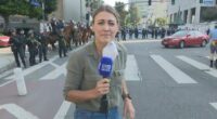 Lauren Tomasi was shot in the leg with a rubber bullet by one of the police officers over her right shoulder.