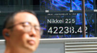 Asian shares post modest gains after Wall Street nears more records