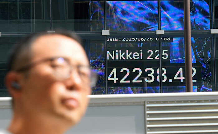 Asian shares post modest gains after Wall Street nears more records