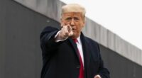 US President Donald Trump points to a member of the audience.
