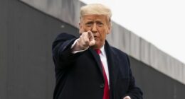 US President Donald Trump points to a member of the audience.