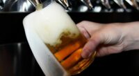 A bartender pours a craft beer.