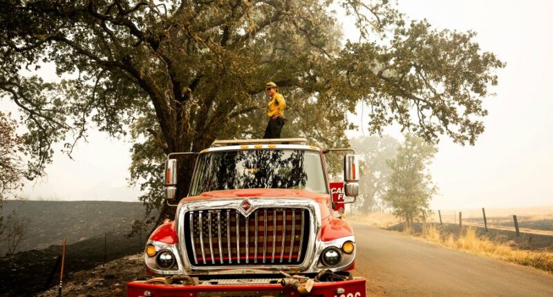 Firefighters try to corral California forest blaze as lightning strikes bring risk of new ignitions