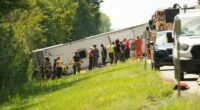 First responders work to rescue victims at the scene of a tour bus that crashed and rolled over on the New York State Thruway.