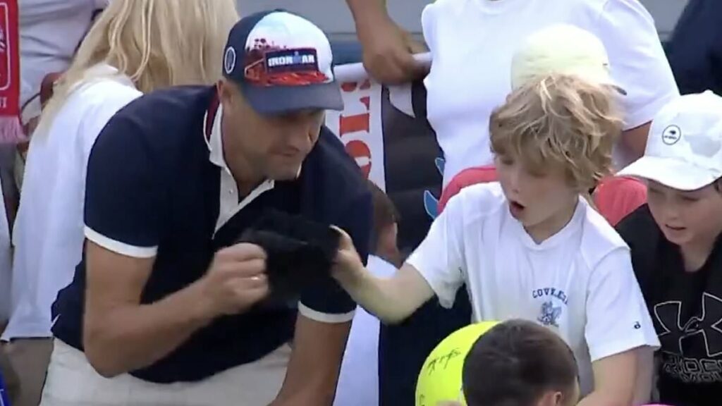 Is this the most hated man on the internet? CEO unmasked after footage of him snatching US Open star's hat out of little boy's hands caused uproar