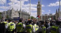 Police officers arrest a demonstrator during a protest in support of the Palestinian People in Gaza, in Parliament Square, in London