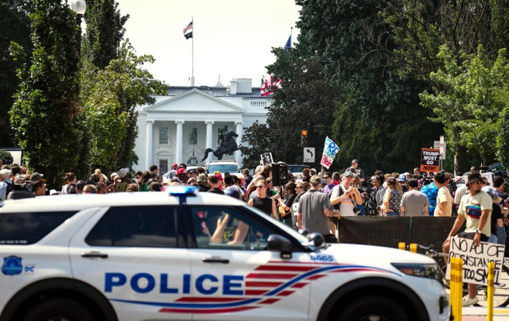 Police car is parked near protestors in DC
