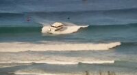 Passenger boat runs aground in high surf off Hawaii beach