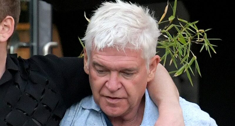 Phillip Schofield, 63, stumbles out of a bar with a 30-year-old male companion in London... while carefree Holly Willoughby lives it up in Portugal