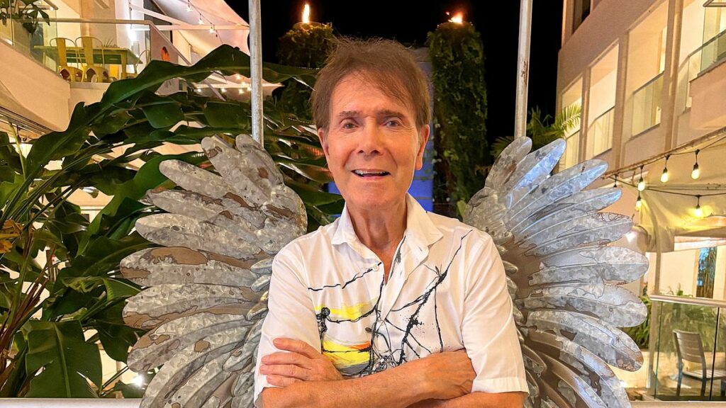 Sir Cliff Richard, 84, shows off his sweet side for 2026 calendar as he offers up biscuits and poses with wings for his highly anticipated annual photoshoot
