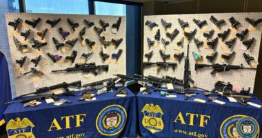 Weapons seized by ATF are displayed during press conference
