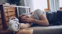Sleeping man disturbed by alarm clock early in the morning