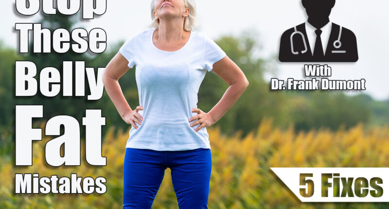 Adult woman with hands on hips looking upwards while wearing blue pants and white tee shirt with blurry yellow flowers in background. 5 Belly Fat Mistakes Everyone Makes According to This Doctor. Cover