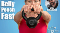 close up of a woman athlete in red sportswear lifting a kettlebell weight against blue background. 6 Standing Exercises That Shrink Belly Pooch Better Than Crunches After 40. Cover
