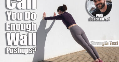 Sporty woman doing press ups against a white wall outside. Over 40? If You Can Do This Many Wall Pushups, Your Strength Is Above Average. Cover