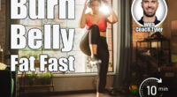 Beautiful Athletic Plus Size Body Positive Sports Woman Uses Smartphone Health Fitness Tracking App, Does Aerobic Exercises, Squatting, Knees to Elbows at Home. Female Training Wearing Headphones. Over 45? These 4 Standing Exercises Burn Belly Fat in 30 Days. Cover