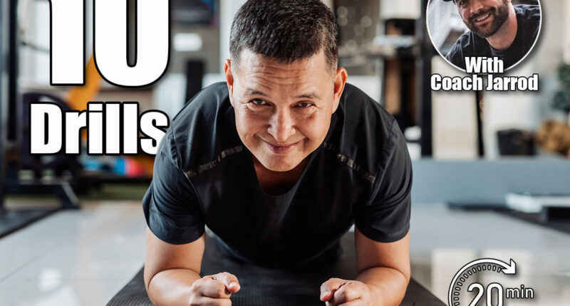 Southeast Asian man in his 50s holds a plank on mat with a confident smile, demonstrating strength and stability in core training. Over 50? If You Can Do These Strength Drills, You’re in Great Shape. Cover,