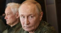 Putin dons his military fatigues 500miles from the frontline