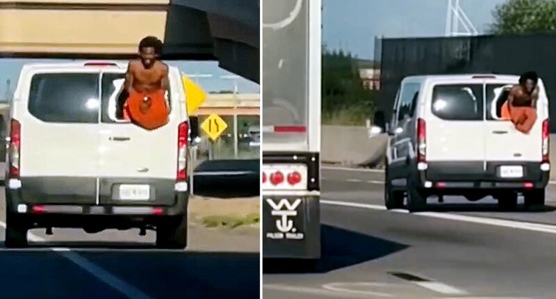 Shirtless inmate in handcuffs hangs out of broken window of prison van