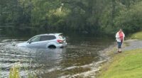 Anti-ICE protester's car sinks as she confronts agents arresting man