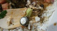 What appears to be a button battery in a Guzman y Gomez burrito bowl.