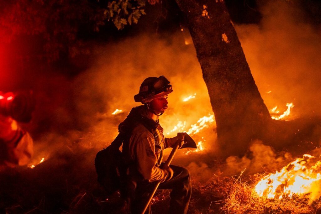 A firefighter is surrounded by flames in  Aetna Springs area of Napa County, Calif.