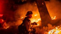 A firefighter is surrounded by flames in  Aetna Springs area of Napa County, Calif.